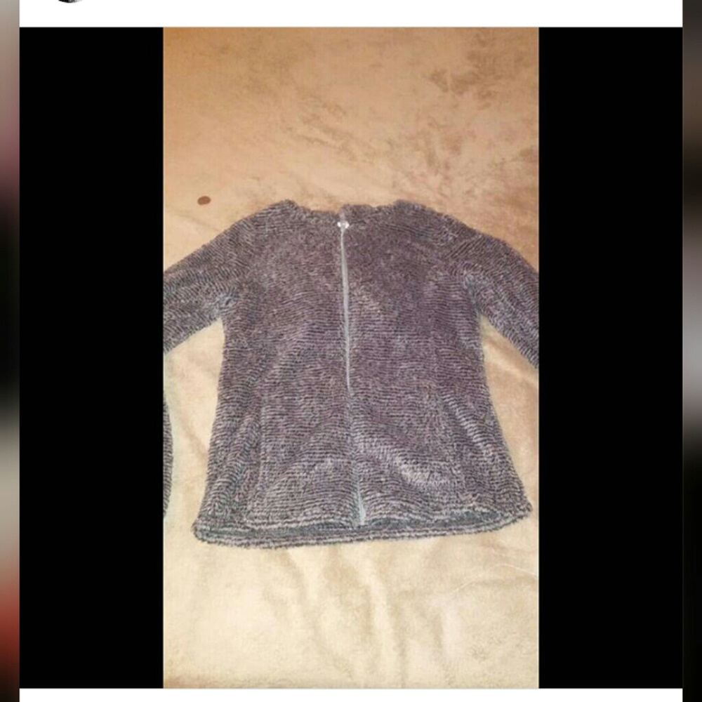 A fuzzy grey and black sweater